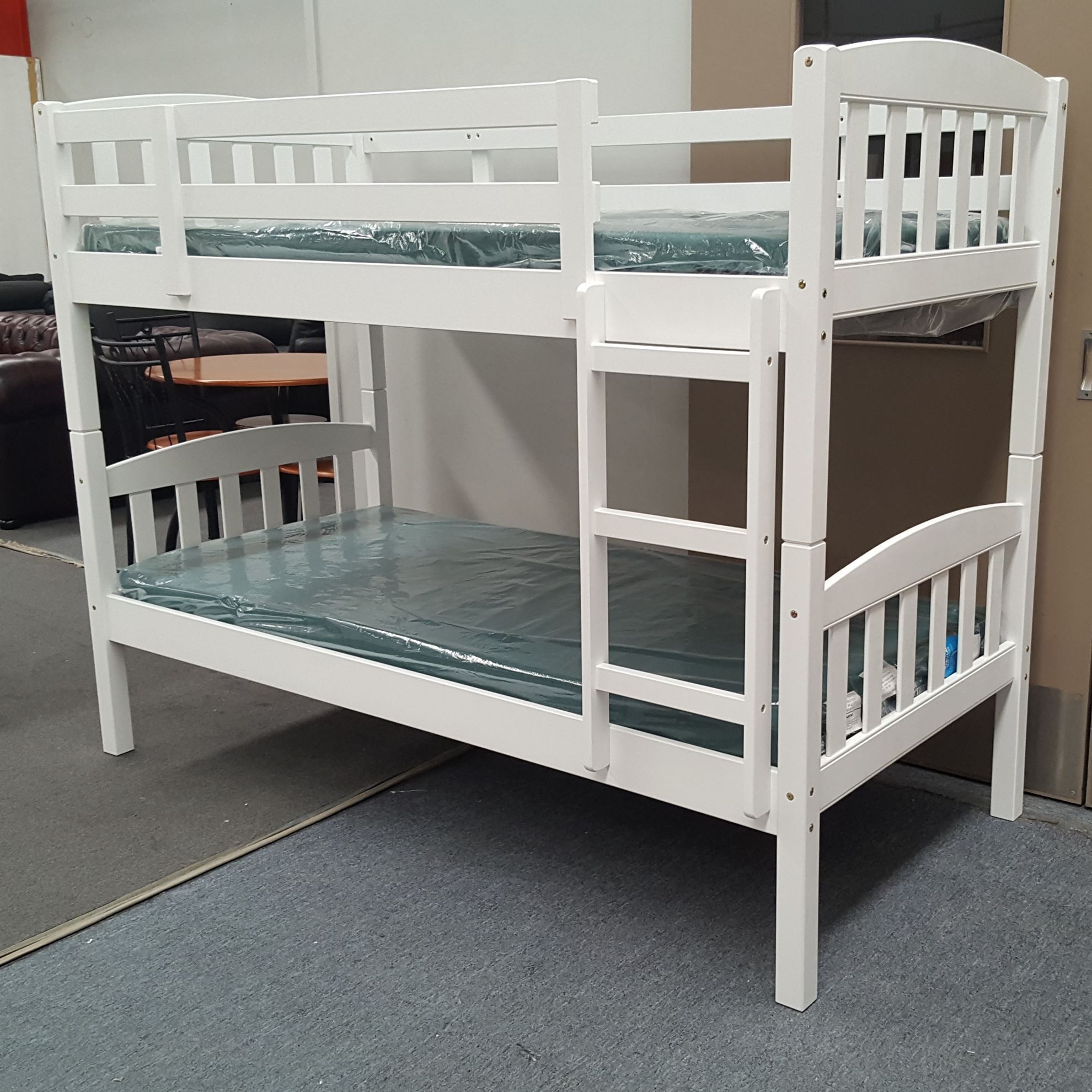 white wooden bunk beds with mattresses