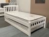 White single bed with wooden frame, mattress, and trundle