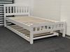 Miki King Single Bed in white, crafted from solid rubberwood, featuring a slatted headboard and footboard with a pull-out trundle for extra sleeping space.