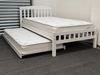 Miki King Single Bed in white, crafted from solid rubberwood, featuring a slatted headboard and footboard with a pull-out trundle for extra sleeping space. Both the main bed and trundle are fitted with comfortable mattresses