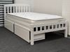 Miki King Single Bed in white, crafted from solid rubberwood, featuring a slatted headboard and footboard with built-in storage drawers for practical organization. The main bed is fitted with a comfortable mattress