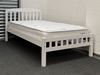 Miki King Single Bed in white, crafted from solid rubberwood, featuring a slatted headboard and footboard. The main bed is fitted with a comfortable mattress. Title: Miki King Single Bed – Solid Hardwood Frame with Mattress in White Let me know if you'd like any further refinements!